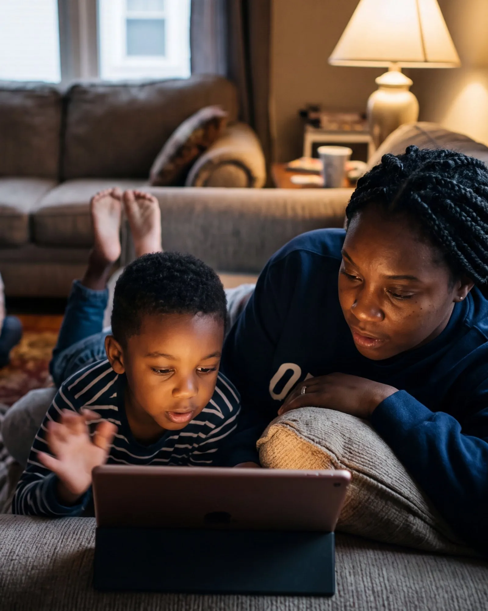 A mom and her son using SumPup on the couch